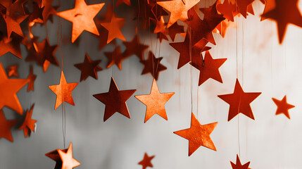 Wall Mural - celestial garland: a cascade of paper stars in warm hues creates a mesmerizing and enchanting displa