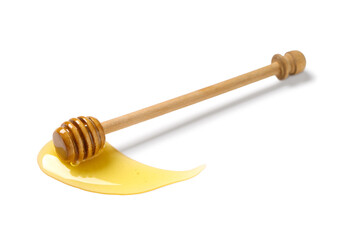 Spilled sweet honey and wooden dipper isolated on white background