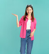 © sitthiphong - Portrait of confident Asian business woman casual pink shirt and show hands with open palms on side isolated on blue background.