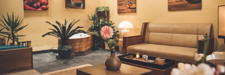 Canvas Print - Cozy sitting room decorated with plants and wooden furniture