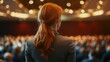 © Almahyra - Woman speaker addressing large conference audience