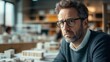 © kurostd - Architect Contemplating Building Models In Office