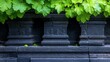 © Preecha - A close-up of intricate stone carvings on a temple wall, with lush green leaves framing the background, showcasing the detailed artistry and cultural significance while hinting at the stories waiting