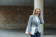 © Cavan - Professional woman engaging in business call outdoors