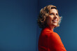 © Jacob Lund - Confident middle-aged businesswoman in a vibrant monochromatic set with blue and orange colorblocking, looking determined