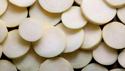 Fototapete - Detailed view of fresh turnip slices, emphasizing their crisp texture and white color. Perfect for healthy food, salads, or vegetable concepts. Texture, background.