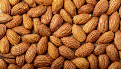 Fototapete - Repeating pattern of raw or roasted almonds, emphasizing their textured surface and warm beige tones. Ideal for healthy snacks, baking, or natural food concepts. Texture, background.
