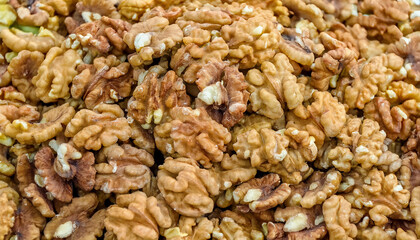 Fototapete - Background featuring peeled walnuts texture, showcasing their smooth surface and light brown color. Ideal for healthy snacks, baking, or natural food concepts. Texture, background.