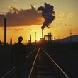 © NAIMAH - Worker walks railroad tracks, refinery sunset