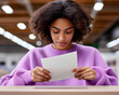 © bcendet - Young woman checks the ballot at voting place. Ballot being cast for election