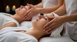 © yozsu - close-up of woman receiving a relaxing facial massage from a professional therapist