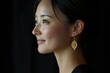 © Mane - Close-up profile shot of a Japanese woman smiling with black hair, set against a black background.