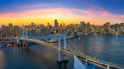 Wall Mural - Rainbow bridge and Tokyo cityscape at sunset, Japan.