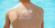 © Anna - A boy applies sunscreen against the background of a swimming pool. Suntan lotion.