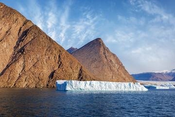 Wall Mural - giant iceberg, glacier and red rock mountains of northeast greenland national park. summer fjord lan