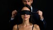 © ANDREY PROFOTO - Captive connection blindfolded woman and man in dark portrait
