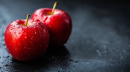 Poster - Fresh and juicy red apples with water droplets on a dark stone surface highlighting their vibrant color : Generative AI