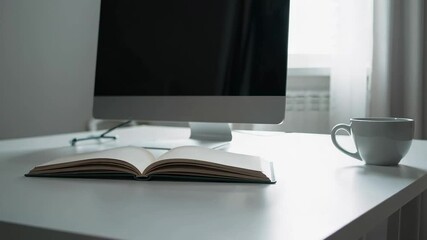 Aufkleber - Office workspace showing a computer screen, an open notebook, and a coffee cup on a white desk, creating a productive and focused atmosphere
