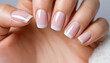 © V. Orlan - Woman's Hand with Classic French Manicure on Soft Background