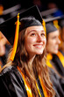 © Lailatul - Graduation A smiling graduate in cap and gown looks optimistic in commencement hall
