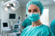 © Pics_With_Love - Medical professional in scrubs and mask preparing for a surgical procedure in a modern operating room