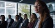 © Stock Pix - Business presentation with professional woman speaking to diverse audience in a bright, modern conference room during a daytime seminar.