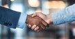 © Stock Pix - Two people in professional attire clasping hands in a handshake. Symbolizing agreement, welcome, and mutual respect between the business parties