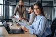 © standret - Documents in hands. Professional workers are in the modern office together