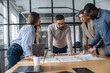 © standret - Talking, discussion of the plan. Professional workers are in the modern office together