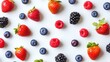 © pinporn manosri - Minimalist flat lay of assorted berries, including strawberries, blueberries, and raspberries, scattered on a clean white background.