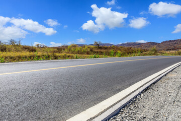 Wall Mural - asphalt road and white cloud natural landscape under the blue sky
