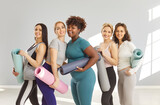 Group portrait of a multinational team of women athletes during a workout session at the gym. Fitness training, diversity, and teamwork, showcasing dedication to sport and active lifestyles.