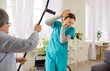 © Studio Romantic - Aggressive elderly woman threatening with crutch to frightened nurse have disagreement being dissatisfied with medical help has bad mood mental problems feels furious. Old people care