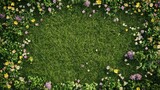 Top view of a lush green grass field with vibrant wildflowers scattered across, perfect for spring and summer designs.