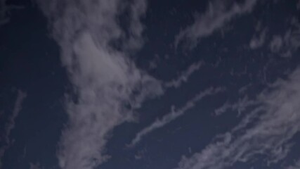 Fototapete - Unique cloud patterns against a dark evening sky create a serene atmosphere for nighttime observation