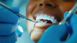 © jobim - Close-up of a young woman smiling during a dental check-up, showing dental tools in action, representing professional oral health care and patient comfort.