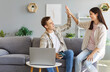 © Studio Romantic - Happy family couple sitting on couch with laptop computer and mobile phone give each other high five after successful Internet shopping or making online banking transaction