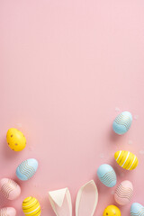 Wall Mural - Decorative Easter eggs and bunny ears placed artistically on a pink minimalistic background