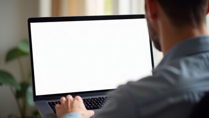 Rear view on white blank screen over shoulder man typing on laptop keyboard
