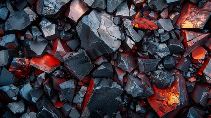 Poster - Black and red obsidian crystals are scattered across a surface, highlighting their sharp edges and smooth surfaces. Natural light accentuates their vibrant colors and intricate patterns.