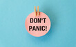© Pawel - A pink paper with the words Don't Panic written on it