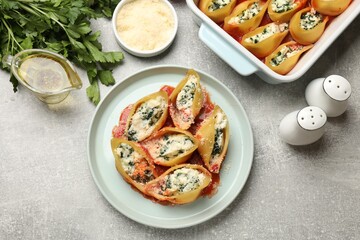 Wall Mural - Delicious shell pasta stuffed with ricotta and spinach served on light grey table, flat lay