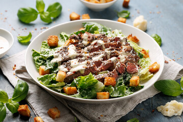 Wall Mural - Beef steak Caesar salad with croutons, parmesan cheese and lettuce. Healthy food