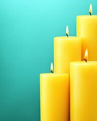 Wall Mural - bright yellow candles on a turquoise background for warm atmosphere