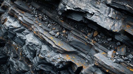 Leinwandbilder - Close up view of unique rock layers highlighting the contrast between dark minerals and patches of orange lichen, illustrating geological processes in a natural setting under sunlight.