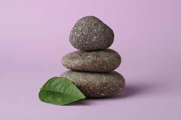 Wall Mural - Stack of rocks on lilac background. Harmony and life balance