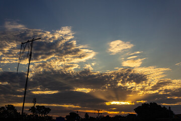 Wall Mural - sunset sky with clouds and electricity pole in the countryside of thailand