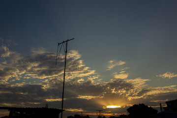 Wall Mural - sunset sky with clouds and electricity pole in the countryside of thailand