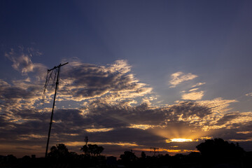 Wall Mural - sunset sky with clouds and electricity pole in the countryside of thailand