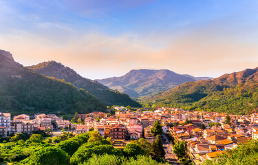 Wall Mural - Mountain town view. Mountain landscape of  beautiful village in Sicily, Italy. A town in a beautiful mountain valley. Mountain valley town during sunset in evening light